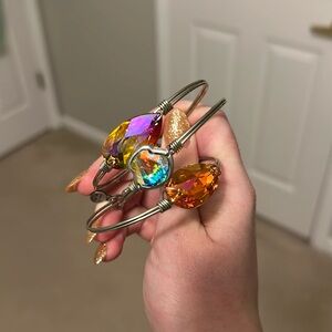 3 silver bracelets with iridescent jewels